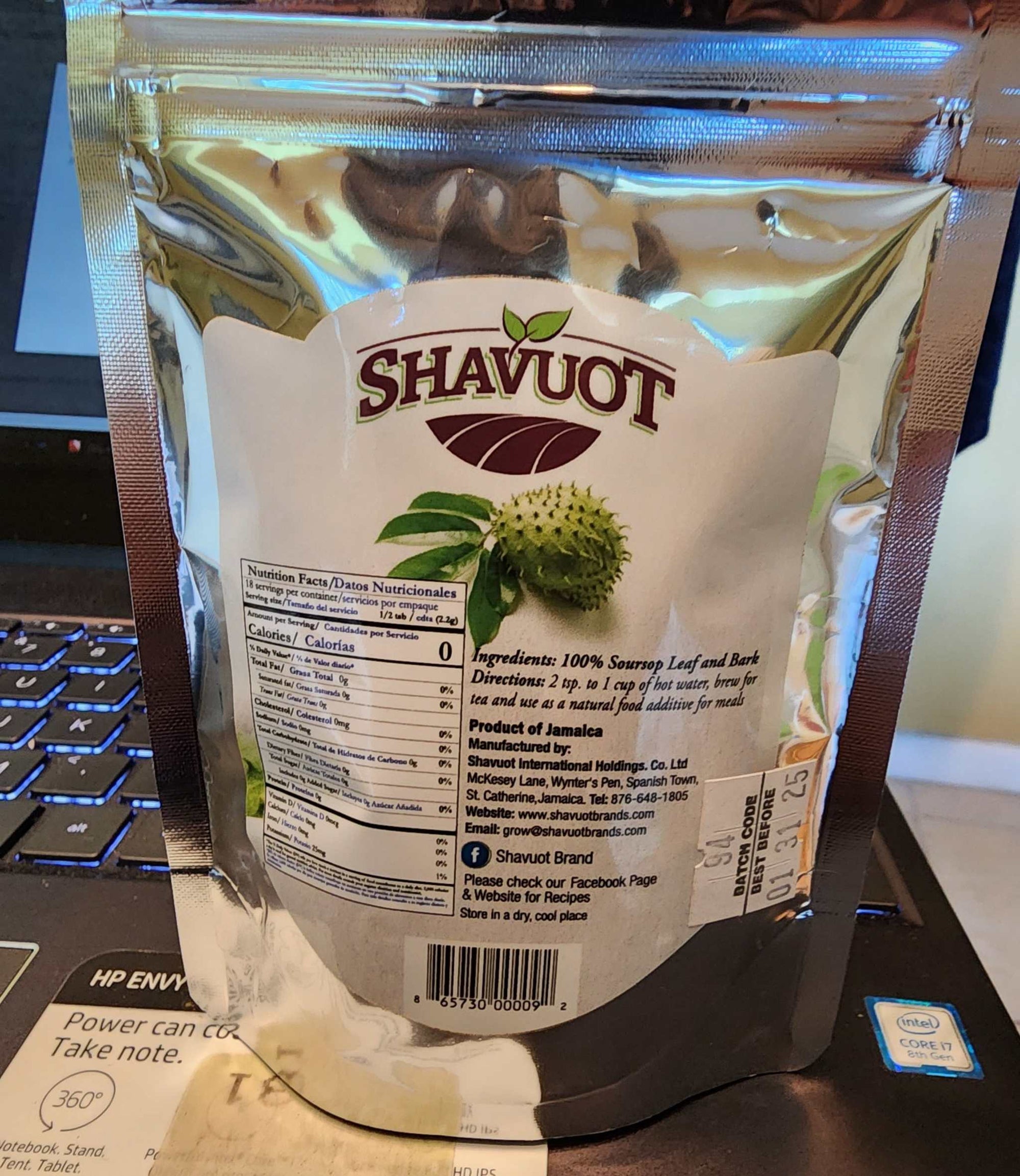 Shavuot Soursop powder packaging on a laptop, showcasing its health benefits and Jamaican origin.