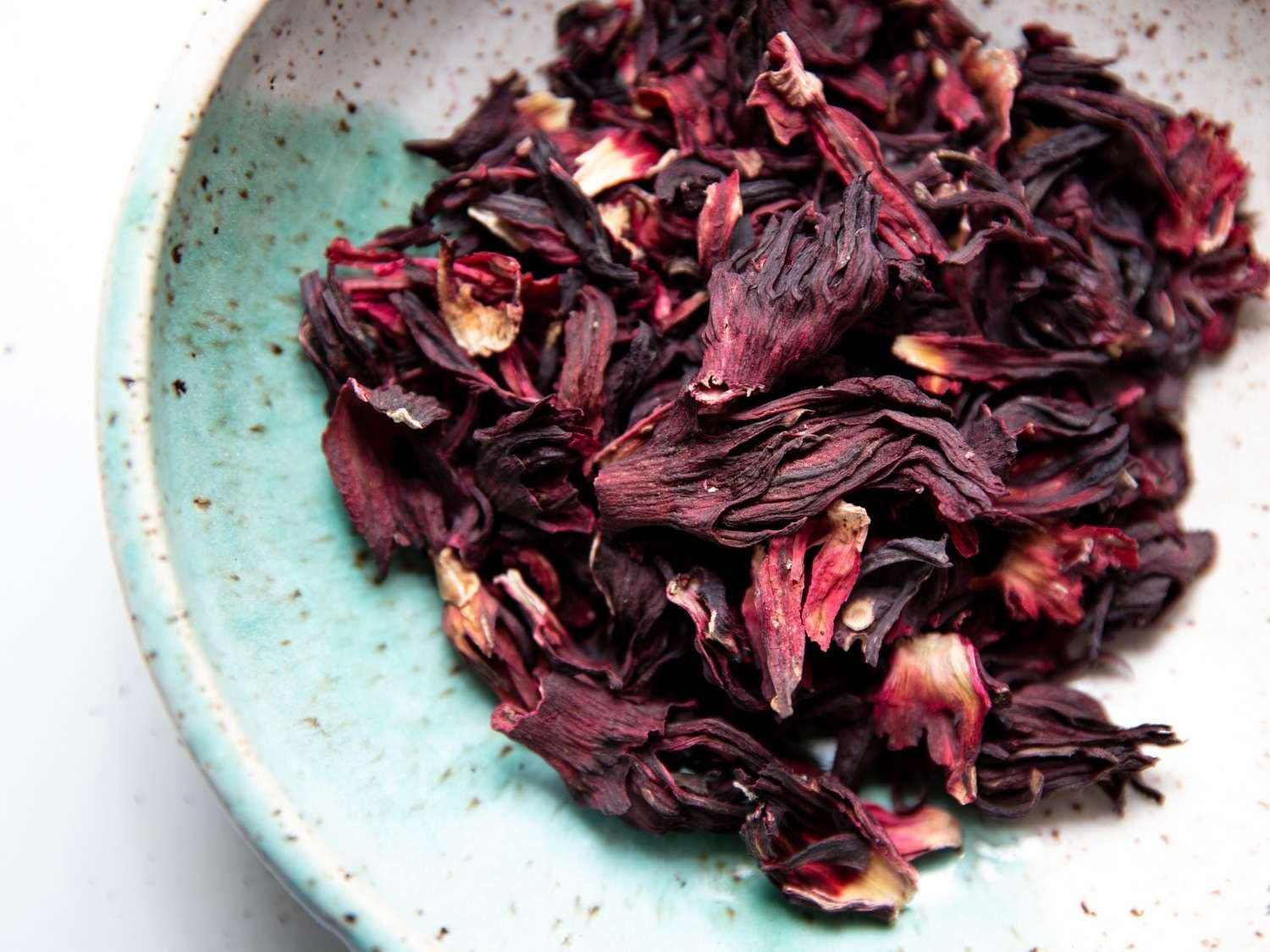 Dried Jamaican Sorrel Hibiscus petals in a ceramic bowl.