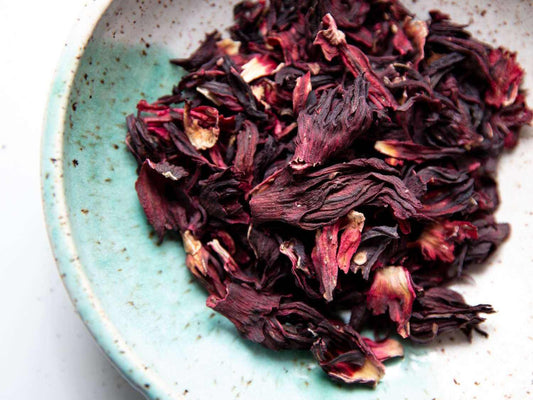 Dried Jamaican Sorrel Hibiscus petals in a ceramic bowl.