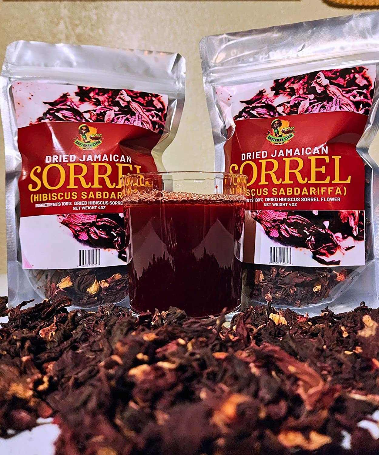 Dried Jamaican Sorrel Hibiscus packaging with a glass of brewed tea and scattered dried leaves.